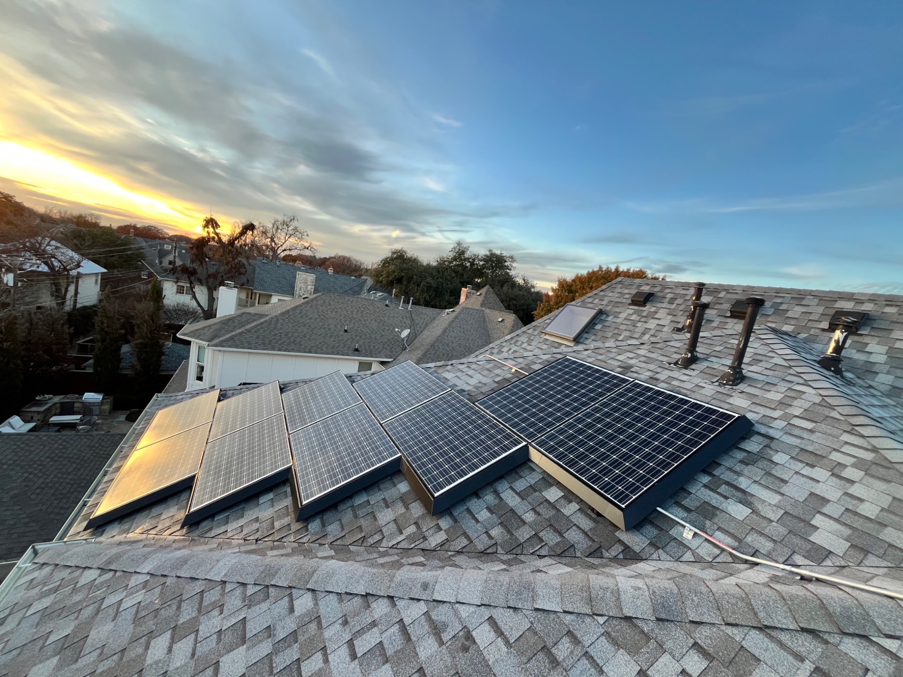 Clean residential solar panels at sunset